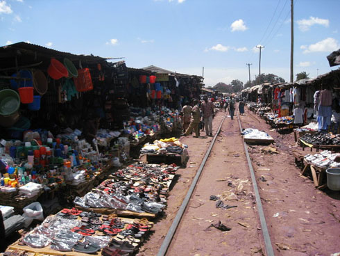 Photo by Amnesty.org.uk of market stalls before the railway line in Kibera