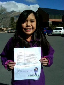 Jamie Lynn Butler holds her Letter to President Obama