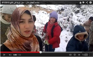 Children, internally displaced within Syria, gather firewood. One comments, "we are laughing at our lives."